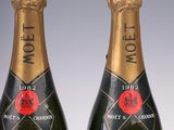 two bottles of moet champagne on a white surface