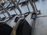 a row of stationary exercise bikes in a gym