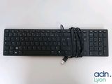 a black keyboard that is connected to a charger