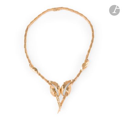 a gold necklace with a bird ' s head on it