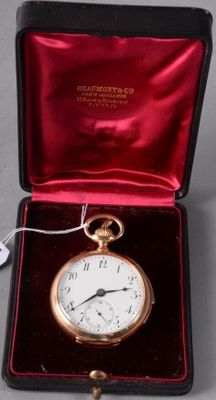 a small gold pocket watch in a red case