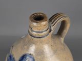 a blue and white vase with a horse on it