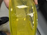 a person holding a yellow container with a yellow lid