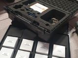 a black case sitting on top of a floor next to a pile of papers