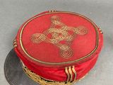 a red hat with a gold design on it