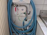 un tuyau bleu raccordé à un réservoir d'eau dans une salle de bains