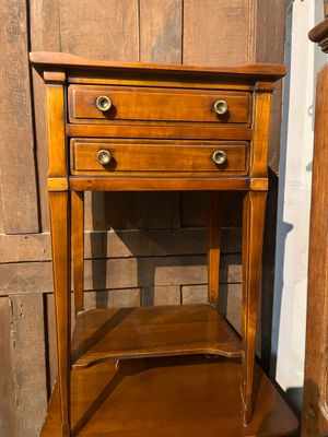 a wooden table with two drawers and a shelf on top of it