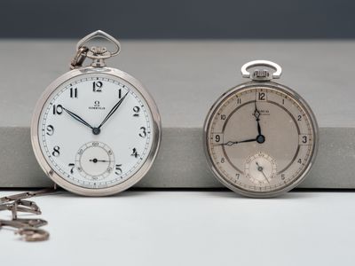 two clocks sitting next to each other on a table