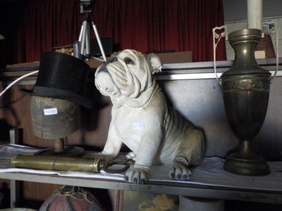 a statue of a bulldog sitting on a shelf