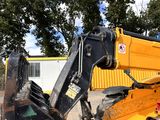 a backhoe of a construction vehicle parked in a parking lot