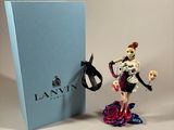 a figurine of a skeleton riding a horse next to a blue box