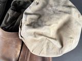 two pairs of gloves and a hat sitting on a table