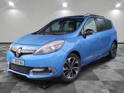 a blue car is parked in a room with a checkered floor