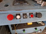 a close up of a machine with red and green buttons