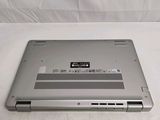 a silver laptop that is sitting on a white surface