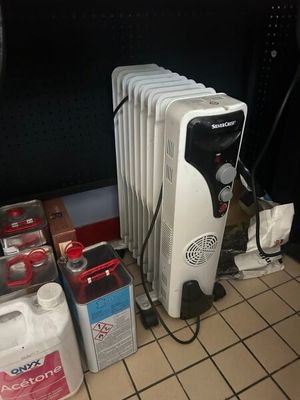 un radiateur posé à même le sol, à côté d'autres objets