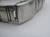 a close up of a watch on a white surface
