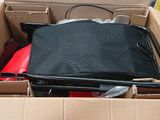 a black suitcase in a box with other items in it