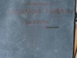 an old suitcase with a sign on it sitting on a table