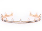 a close up of a gold bracelet with pearls and diamonds