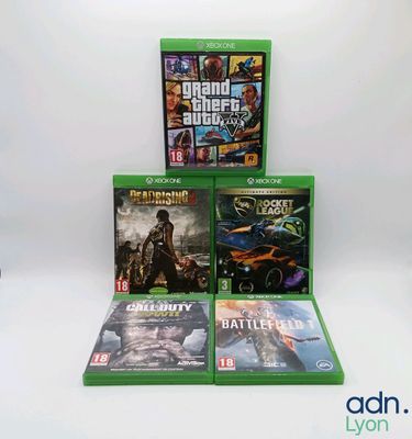 three xbox game consoles sitting on top of each other in front of a white background