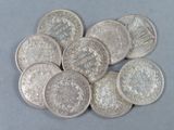 a pile of silver coins sitting on top of a table