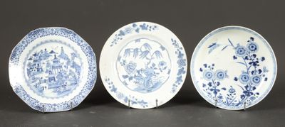 three blue and white plates with birds and flowers on them