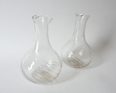 pair of clear glass vases sitting on a white surface