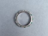 a close up of a diamond and emerald ring on a table