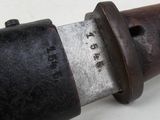 a close up of a knife on a white surface