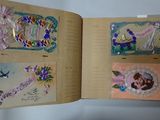 an open book with pictures of flowers and birds on it