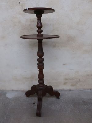 a wooden table with three tiered trays on it