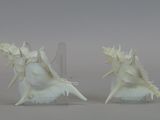 two white angel figurines sitting on top of each other