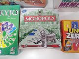 many board games on the table and a cat on the table