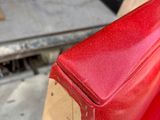 a close up of a piece of wood on the back of a red truck
