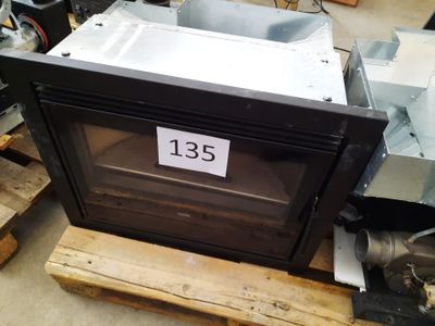 a black oven sitting on a pallet in a warehouse