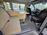 the interior of a van with two seats and a table in the back