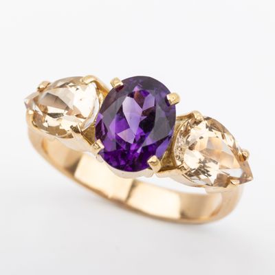 a close up of a ring with an amethorate, citrine and citrine stones
