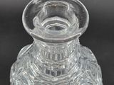 a small clear glass vase on a black surface