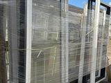 a large stack of windows sitting on a pallet