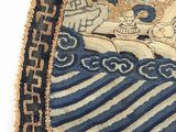 a close up of a blue and beige oriental rug with a lion on it