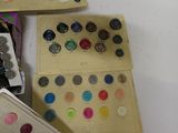 a lot of buttons in a box on the table