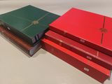 three red and green boxes are stacked on top of each other