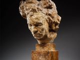 a marble head of a woman on a pedestal
