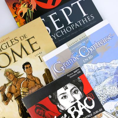 several books on a table with a white background