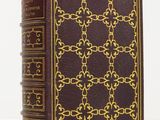 an old book with a golden design on the cover