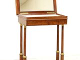 a small wooden desk with a mirror on top of it