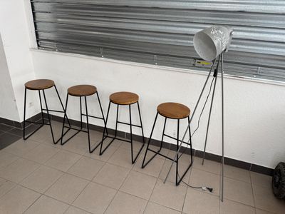 four stools sitting in front of a window in a room