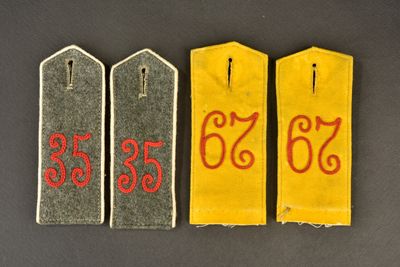 three tags with numbers on them on a black surface