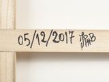 a wooden cross that has a message on it